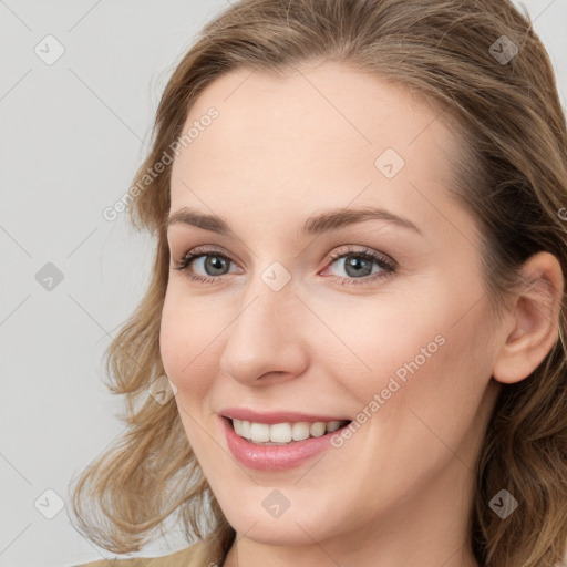 Joyful white young-adult female with long  brown hair and blue eyes