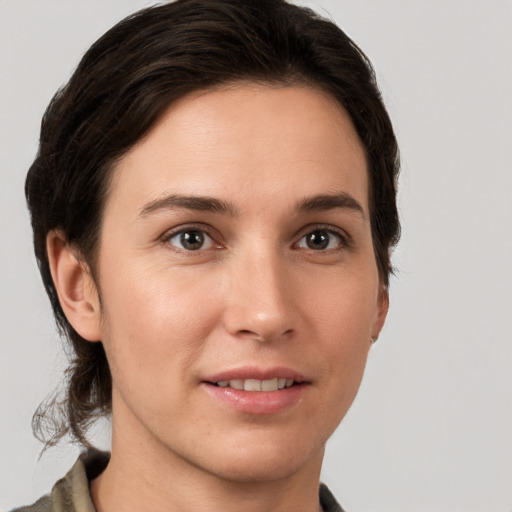 Joyful white young-adult female with medium  brown hair and brown eyes