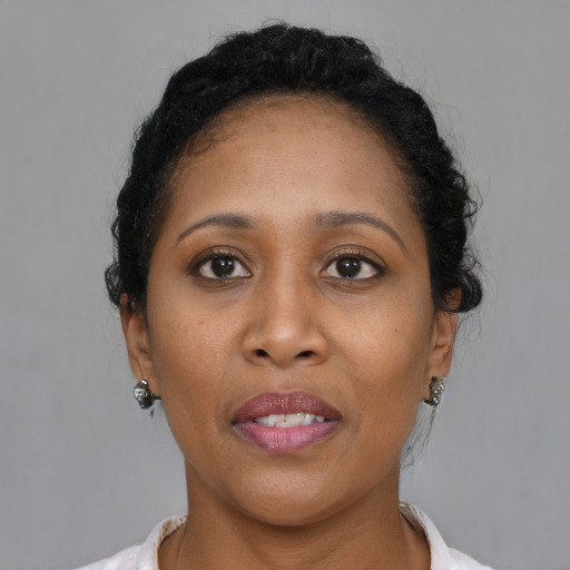 Joyful black adult female with short  brown hair and brown eyes