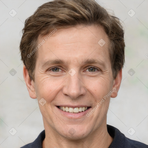 Joyful white adult male with short  brown hair and grey eyes