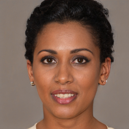Joyful latino young-adult female with short  black hair and brown eyes