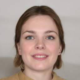 Joyful white young-adult female with medium  brown hair and grey eyes