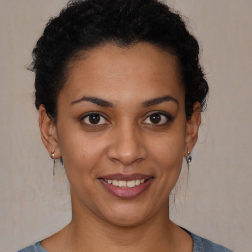 Joyful latino young-adult female with short  brown hair and brown eyes