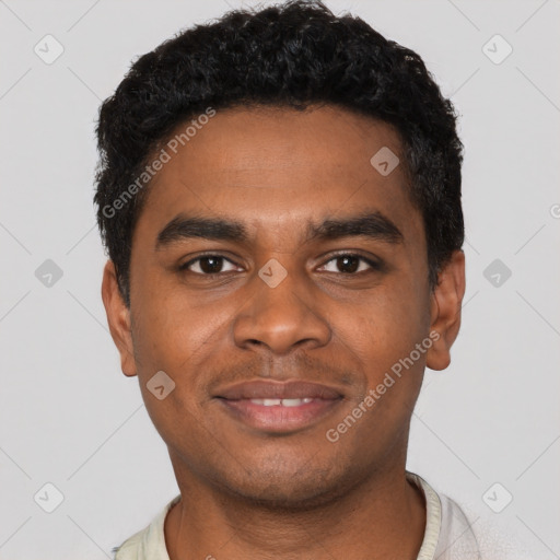 Joyful black young-adult male with short  black hair and brown eyes