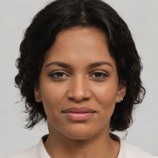 Joyful black young-adult female with medium  brown hair and brown eyes