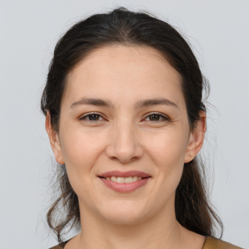 Joyful white young-adult female with medium  brown hair and brown eyes