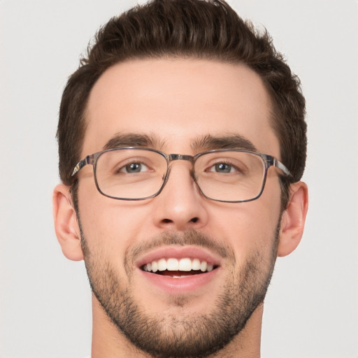 Joyful white young-adult male with short  brown hair and green eyes