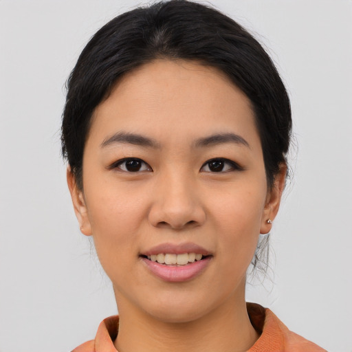 Joyful asian young-adult female with medium  black hair and brown eyes
