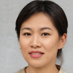 Joyful asian young-adult female with medium  brown hair and brown eyes