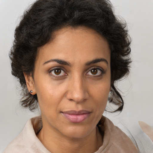 Joyful latino adult female with medium  brown hair and brown eyes