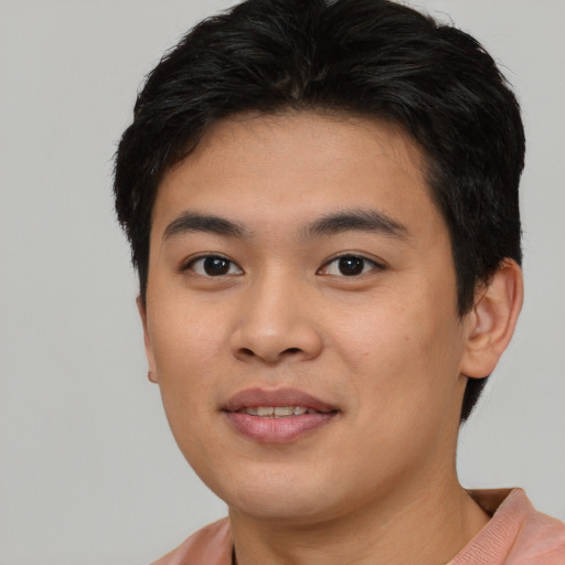 Joyful asian young-adult male with short  black hair and brown eyes
