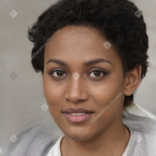 Joyful black young-adult female with short  black hair and brown eyes