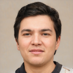 Joyful white young-adult male with short  black hair and brown eyes