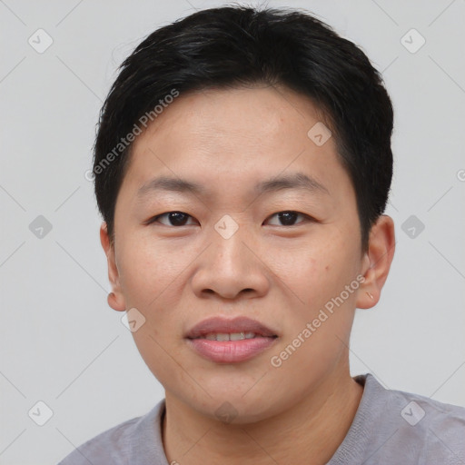 Joyful asian young-adult male with short  black hair and brown eyes