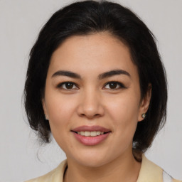 Joyful latino young-adult female with medium  brown hair and brown eyes