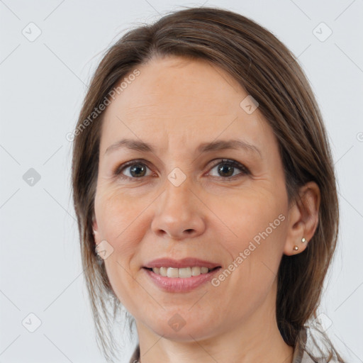 Joyful white adult female with medium  brown hair and brown eyes