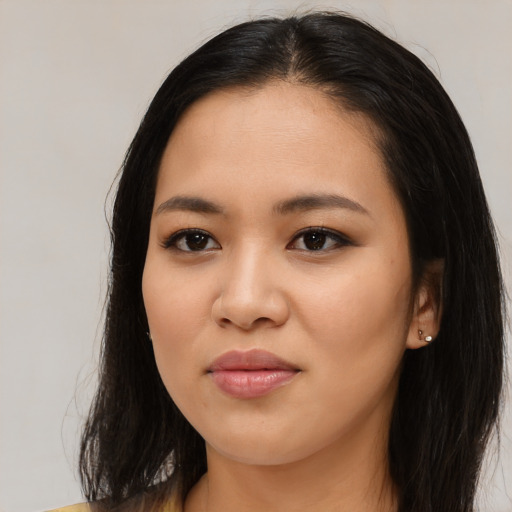 Joyful asian young-adult female with long  brown hair and brown eyes