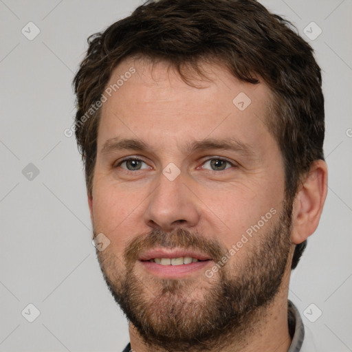 Joyful white adult male with short  brown hair and brown eyes