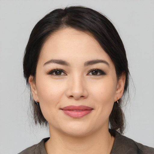 Joyful latino young-adult female with medium  black hair and brown eyes