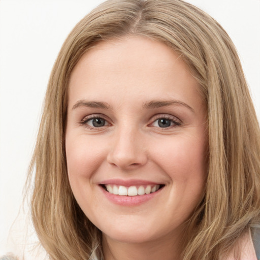 Joyful white young-adult female with long  brown hair and green eyes