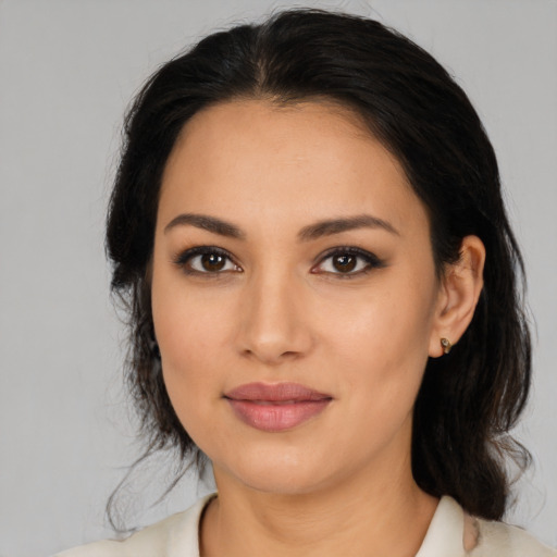 Joyful latino young-adult female with medium  black hair and brown eyes