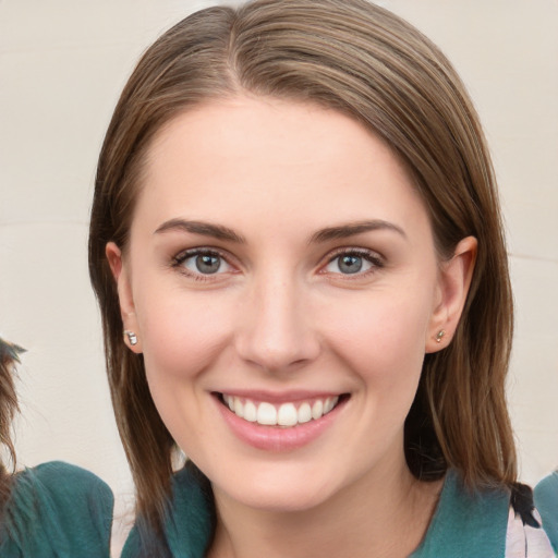 Joyful white young-adult female with medium  brown hair and blue eyes