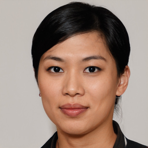 Joyful asian young-adult female with short  black hair and brown eyes