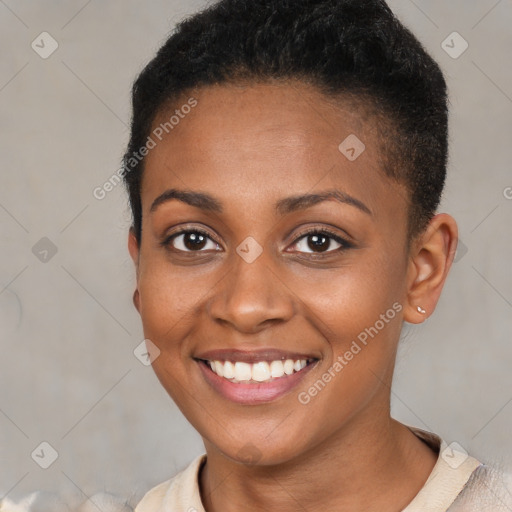 Joyful black young-adult female with short  brown hair and brown eyes