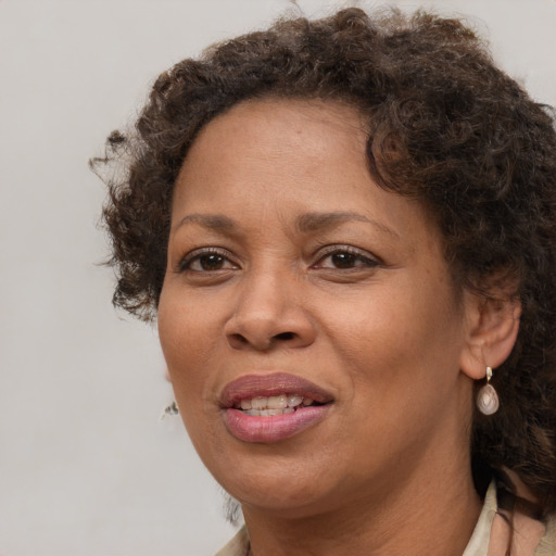 Joyful black adult female with short  brown hair and brown eyes