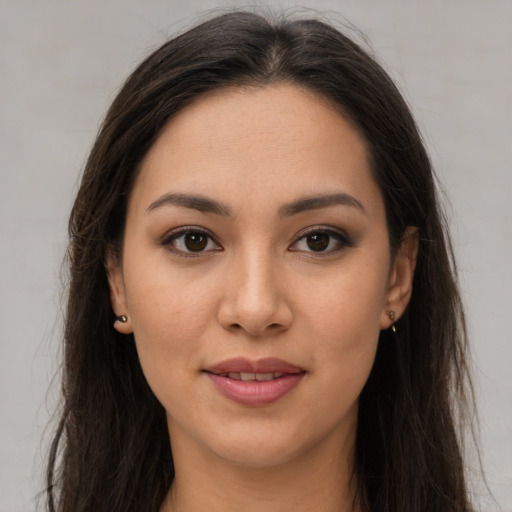 Joyful latino young-adult female with long  brown hair and brown eyes