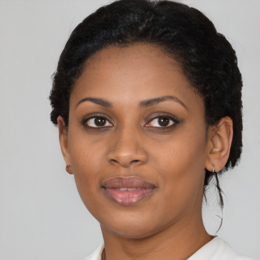Joyful black young-adult female with medium  black hair and brown eyes