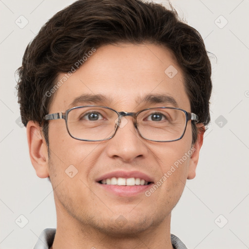 Joyful white adult male with short  brown hair and grey eyes