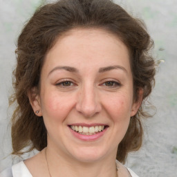 Joyful white adult female with medium  brown hair and grey eyes