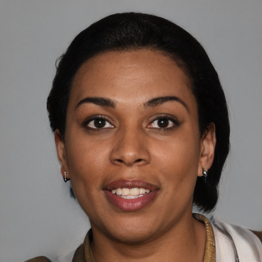 Joyful latino young-adult female with short  black hair and brown eyes