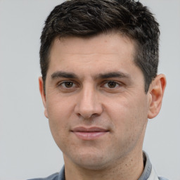 Joyful white adult male with short  brown hair and brown eyes