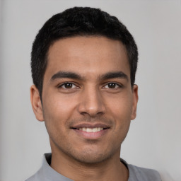 Joyful latino young-adult male with short  black hair and brown eyes