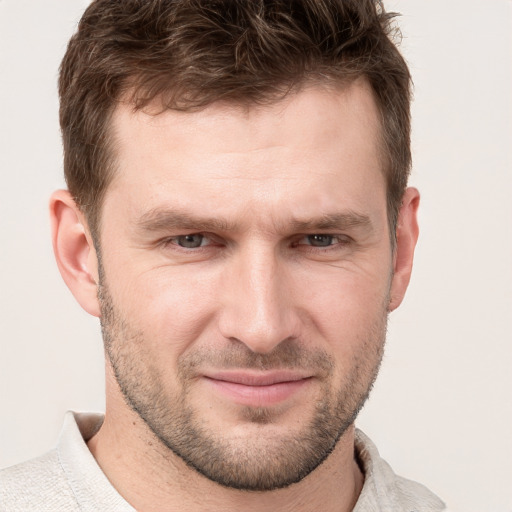 Joyful white adult male with short  brown hair and grey eyes