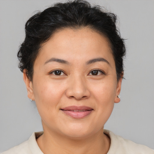 Joyful asian young-adult female with short  brown hair and brown eyes