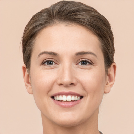 Joyful white young-adult female with short  brown hair and brown eyes