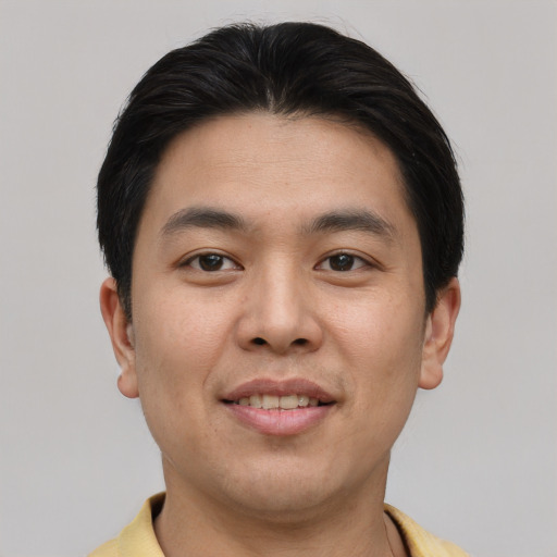 Joyful asian young-adult male with short  brown hair and brown eyes