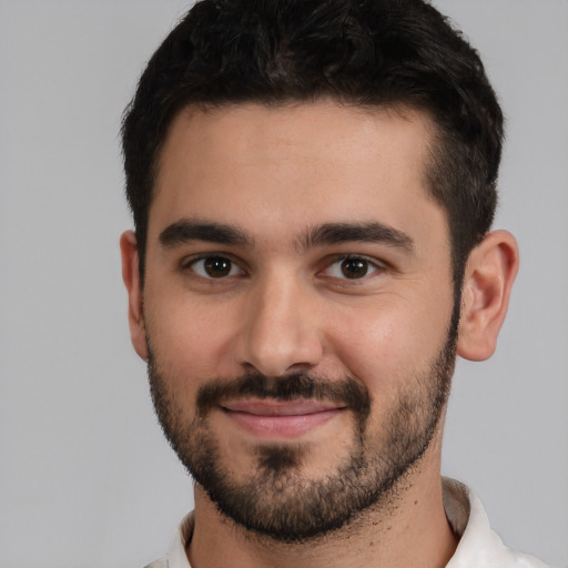 Joyful white young-adult male with short  black hair and brown eyes