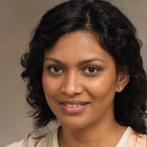 Joyful black young-adult female with medium  brown hair and brown eyes