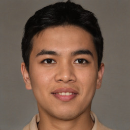 Joyful latino young-adult male with short  brown hair and brown eyes