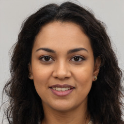 Joyful latino young-adult female with long  brown hair and brown eyes