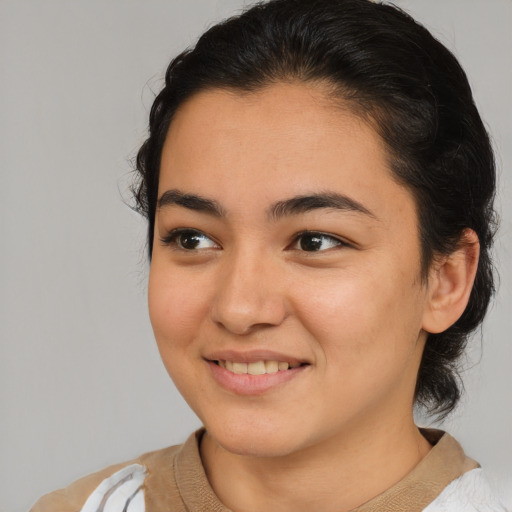 Joyful latino young-adult female with medium  brown hair and brown eyes