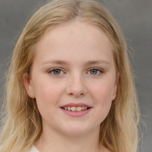 Joyful white child female with long  brown hair and blue eyes