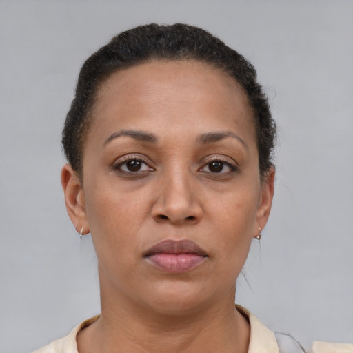 Neutral latino adult female with short  brown hair and brown eyes