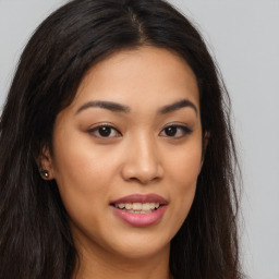 Joyful asian young-adult female with long  brown hair and brown eyes