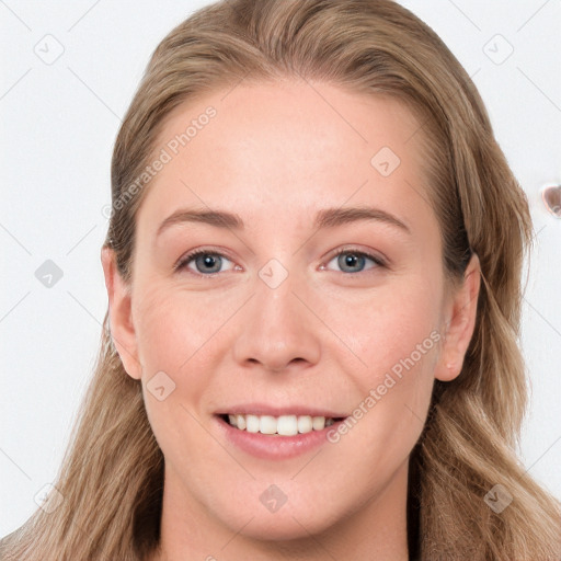 Joyful white young-adult female with long  brown hair and blue eyes