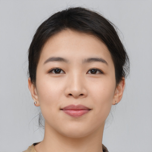 Joyful asian young-adult female with medium  brown hair and brown eyes